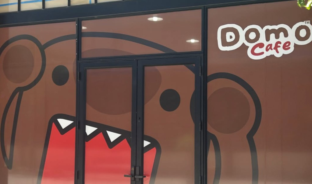 Domo Cafe entrance doors painted with Domo's face