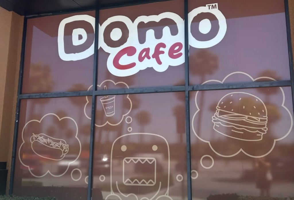 Domo Cafe storefront window with the cafe logo and food doodles