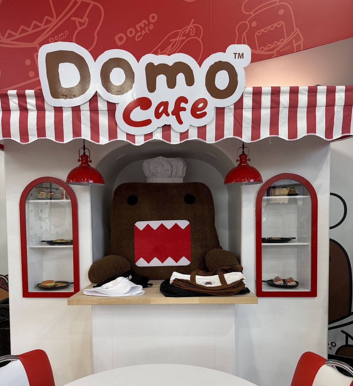 Chef Domo plush under the Domo Cafe sign in Buena Park